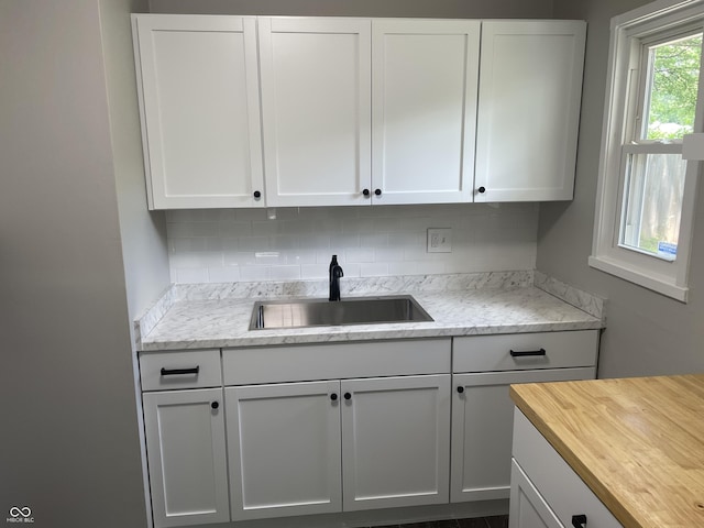 3119 N Fuller Dr, Indianapolis, IN 46224 - kitchen with wooden counters, tasteful backsplash, and white cabinetry