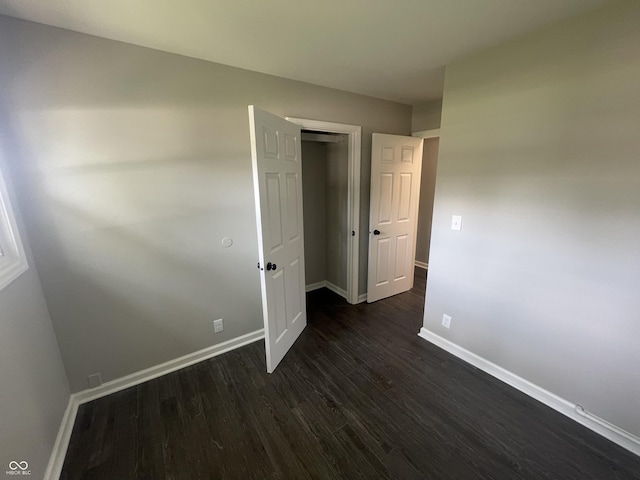 3119 N Fuller Dr, Indianapolis, IN 46224 - unfurnished bedroom with dark wood-style floors and a closet