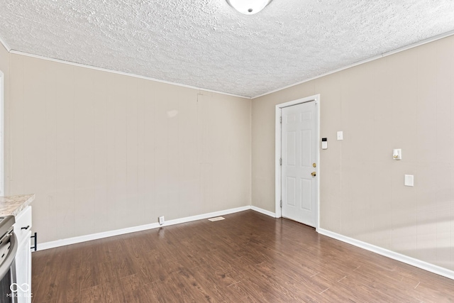 1418 S 7th St, Terre Haute, IN 47802 - unfurnished living room with dark wood-type flooring, a textured ceiling, and ornamental molding