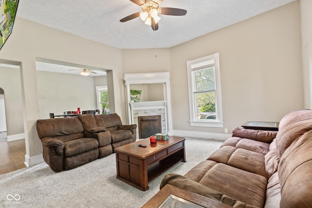 1418 S 7th St, Terre Haute, IN 47802 - carpeted living area featuring ceiling fan, a fireplace, and a textured ceiling