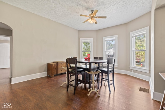 1418 S 7th St, Terre Haute, IN 47802 - dining room with arched walkways, plenty of natural light, a ceiling fan, dark wood-type flooring, and a textured ceiling