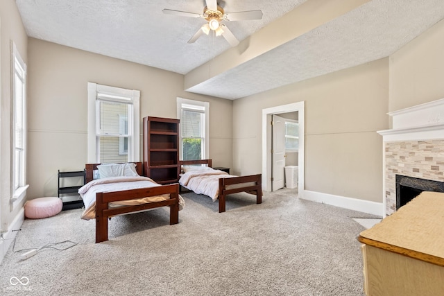1418 S 7th St, Terre Haute, IN 47802 - carpeted bedroom featuring a textured ceiling, a fireplace, a ceiling fan, and ensuite bathroom