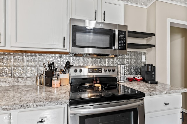 1418 S 7th St, Terre Haute, IN 47802 - kitchen with appliances with stainless steel finishes, open shelves, white cabinets, and backsplash