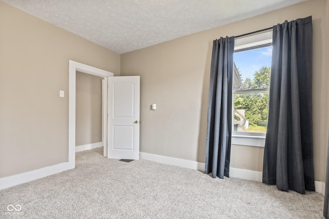 1418 S 7th St, Terre Haute, IN 47802 - empty room featuring carpet and a textured ceiling