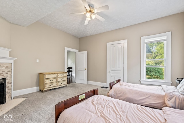 1418 S 7th St, Terre Haute, IN 47802 - carpeted bedroom featuring a textured ceiling, a fireplace with flush hearth, and a ceiling fan
