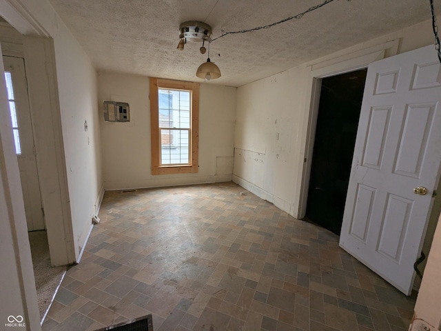 347 E Mechanic St E, Shelbyville, IN 46176 - unfurnished dining area with a textured ceiling and baseboards