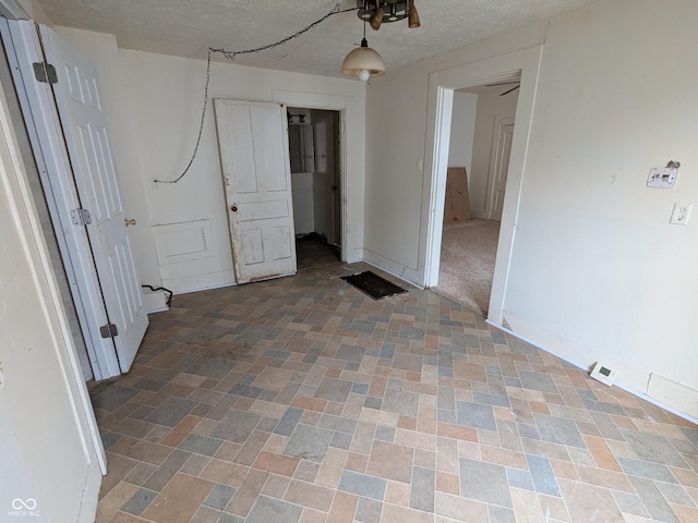 347 E Mechanic St E, Shelbyville, IN 46176 - unfurnished bedroom featuring a textured ceiling and baseboards