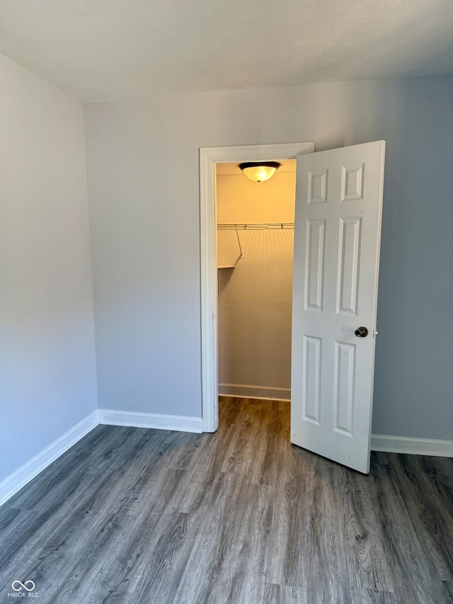 4024 Zinfandel Way, Indianapolis, IN 46254 - unfurnished bedroom featuring wood finished floors and a walk in closet