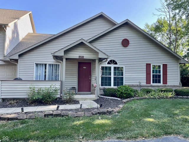 6191 Wildcat Dr, Indianapolis, IN 46203 - view of front facade featuring an attached garage and a front yard