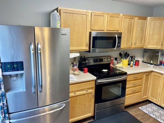 6191 Wildcat Dr, Indianapolis, IN 46203 - kitchen with appliances with stainless steel finishes, light brown cabinetry, light countertops, and dark wood-style flooring