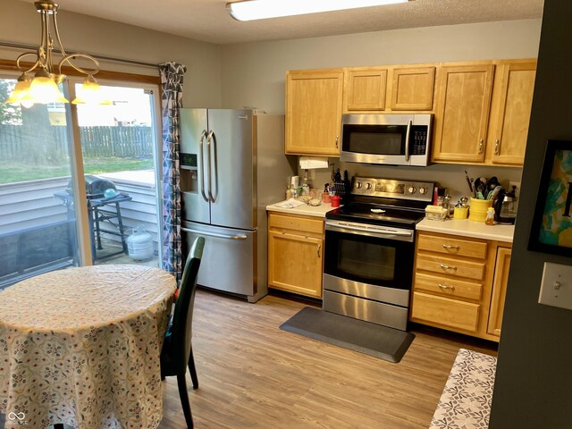 6191 Wildcat Dr, Indianapolis, IN 46203 - kitchen featuring appliances with stainless steel finishes, light countertops, light wood-style flooring, and light brown cabinetry