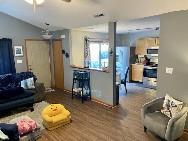 6191 Wildcat Dr, Indianapolis, IN 46203 - living room with dark wood-type flooring, ceiling fan, lofted ceiling, and a textured ceiling