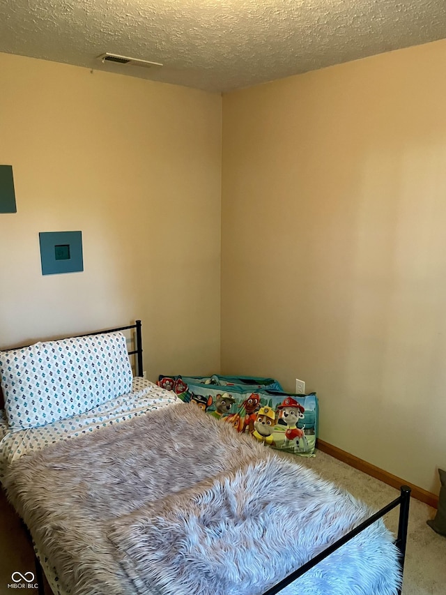 6191 Wildcat Dr, Indianapolis, IN 46203 - carpeted bedroom featuring a textured ceiling and baseboards