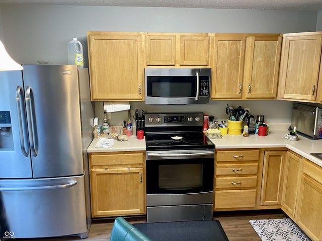 6191 Wildcat Dr, Indianapolis, IN 46203 - kitchen featuring appliances with stainless steel finishes, light brown cabinetry, and light countertops