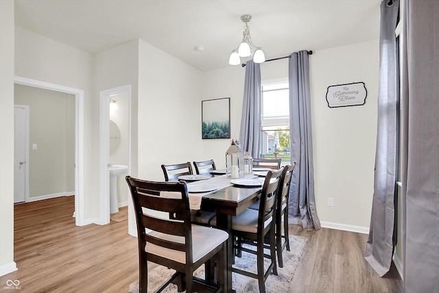 2738 Pointe Club Rd, Indianapolis, IN 46229 - dining area with light wood finished floors and a chandelier