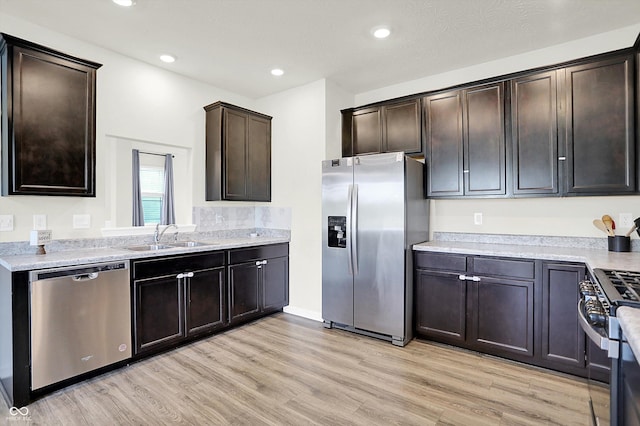 2738 Pointe Club Rd, Indianapolis, IN 46229 - kitchen with stainless steel appliances, light wood-style flooring, dark brown cabinets, light countertops, and recessed lighting