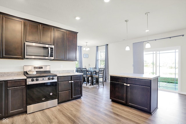 2738 Pointe Club Rd, Indianapolis, IN 46229 - kitchen featuring stainless steel appliances, light wood-type flooring, dark brown cabinets, light countertops, and plenty of natural light