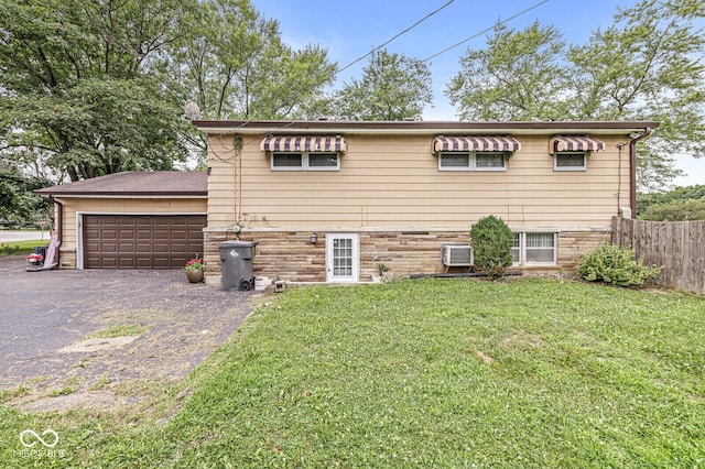 6241 S Meridian St, Indianapolis, IN 46217 - view of side of home with a garage, a wall mounted AC, and driveway