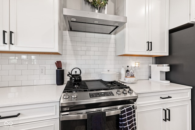 19677 Sumrall Pl, Westfield, IN 46074 - kitchen with stainless steel gas range, wall chimney exhaust hood, white cabinets, and tasteful backsplash