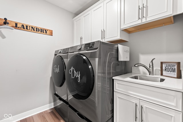 19677 Sumrall Pl, Westfield, IN 46074 - laundry room featuring separate washer and dryer, cabinet space, and wood finished floors