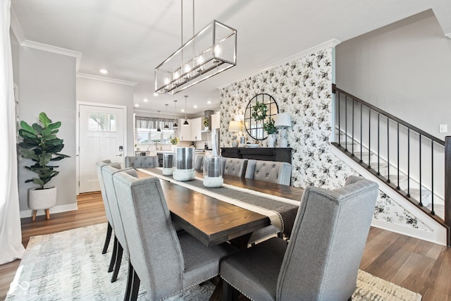 19677 Sumrall Pl, Westfield, IN 46074 - dining room featuring wood finished floors, a chandelier, stairway, ornamental molding, and recessed lighting