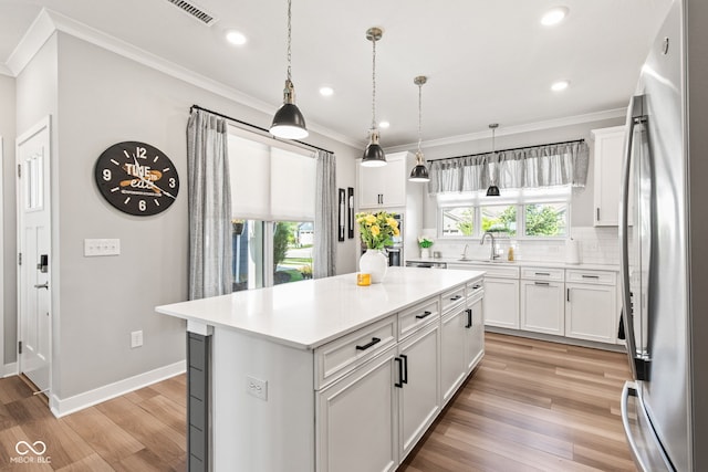 19677 Sumrall Pl, Westfield, IN 46074 - kitchen with stainless steel refrigerator, light wood-style floors, light countertops, tasteful backsplash, and recessed lighting