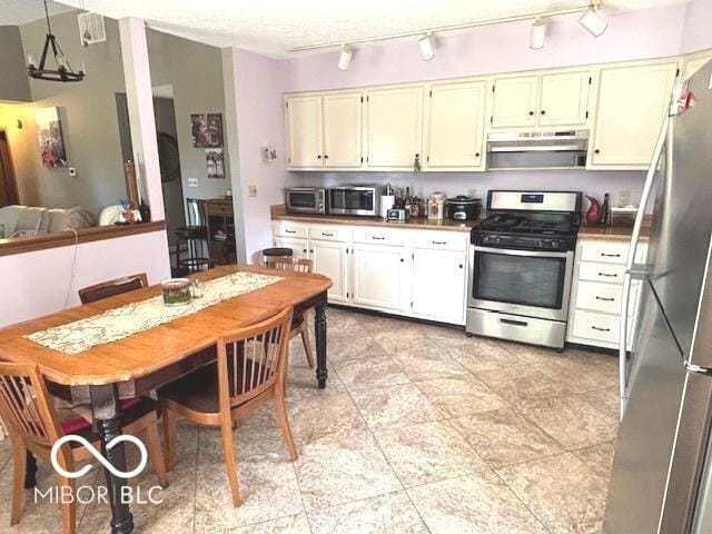 11 Mccutcheon Dr, Lafayette, IN 47909 - kitchen with appliances with stainless steel finishes, under cabinet range hood, and track lighting