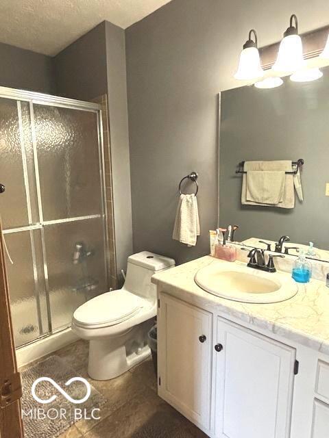 11 Mccutcheon Dr, Lafayette, IN 47909 - full bath featuring vanity, a stall shower, a textured ceiling, and tile patterned flooring