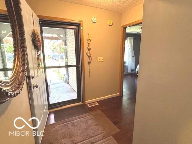 11 Mccutcheon Dr, Lafayette, IN 47909 - entryway featuring a textured ceiling and dark wood-style floors