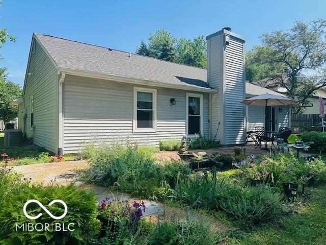 11 Mccutcheon Dr, Lafayette, IN 47909 - back of house featuring a chimney and a patio area