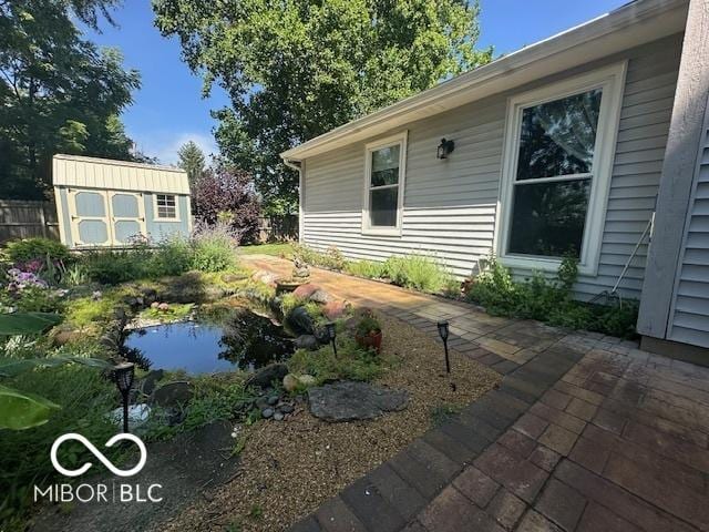 11 Mccutcheon Dr, Lafayette, IN 47909 - view of yard with a shed, a garden pond, and a patio