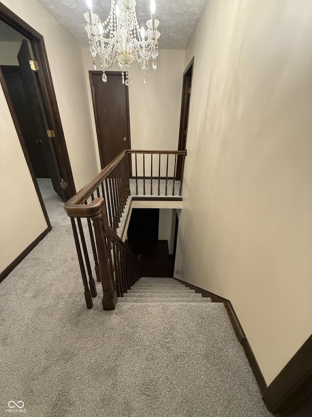 11698 N Bethesda Rd, Mooresville, IN 46158 - stairway with carpet floors, a chandelier, and a textured ceiling