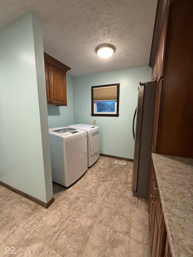 11698 N Bethesda Rd, Mooresville, IN 46158 - washroom featuring washing machine and clothes dryer, cabinet space, electric panel, and a textured ceiling