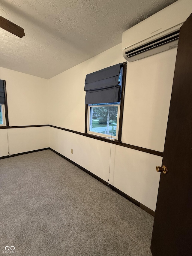 11698 N Bethesda Rd, Mooresville, IN 46158 - carpeted empty room featuring a wall mounted air conditioner and a textured ceiling