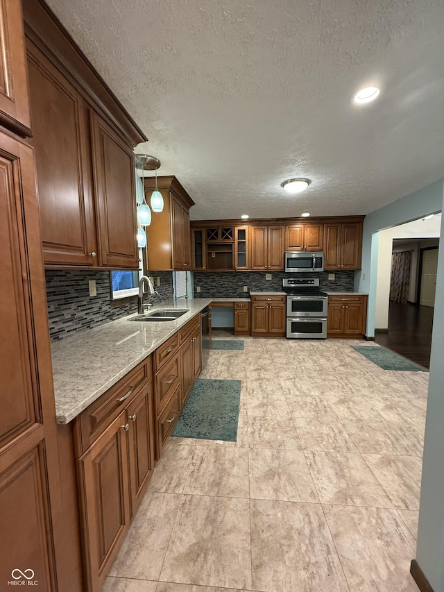 11698 N Bethesda Rd, Mooresville, IN 46158 - kitchen featuring stainless steel appliances, tasteful backsplash, a textured ceiling, glass insert cabinets, and decorative light fixtures