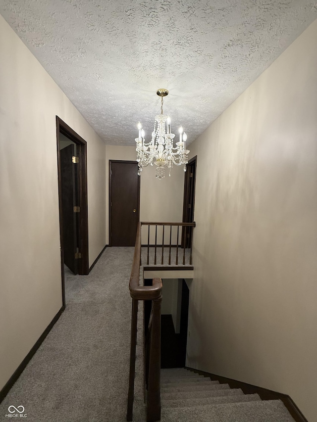 11698 N Bethesda Rd, Mooresville, IN 46158 - hall with a chandelier, carpet flooring, and a textured ceiling