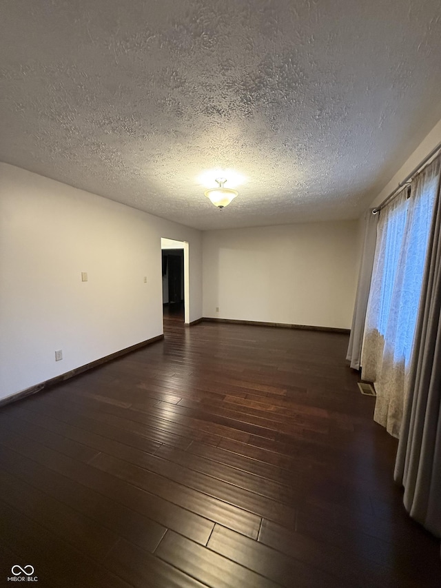 11698 N Bethesda Rd, Mooresville, IN 46158 - unfurnished room featuring a textured ceiling and dark wood-type flooring