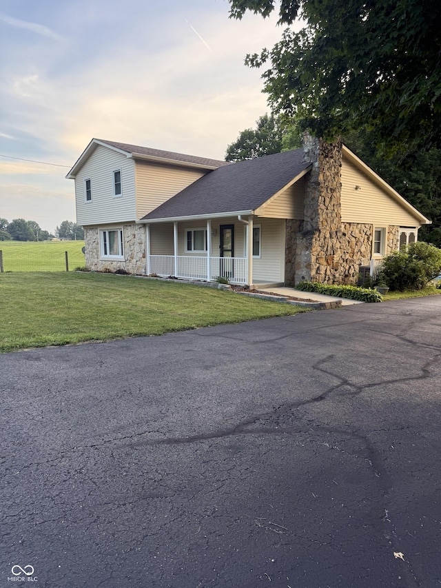 11698 N Bethesda Rd, Mooresville, IN 46158 - view of front facade featuring stone siding, covered porch, and a front yard