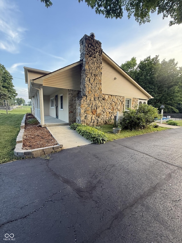11698 N Bethesda Rd, Mooresville, IN 46158 - view of front of property featuring stone siding, a chimney, and driveway