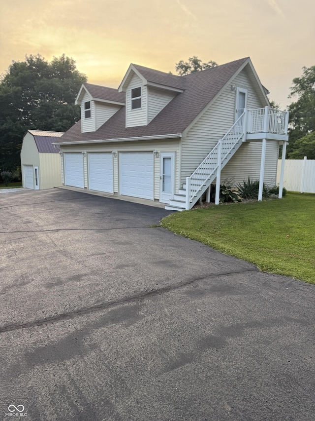 11698 N Bethesda Rd, Mooresville, IN 46158 - view of front of property with asphalt driveway, stairs, a shingled roof, an attached garage, and an outbuilding