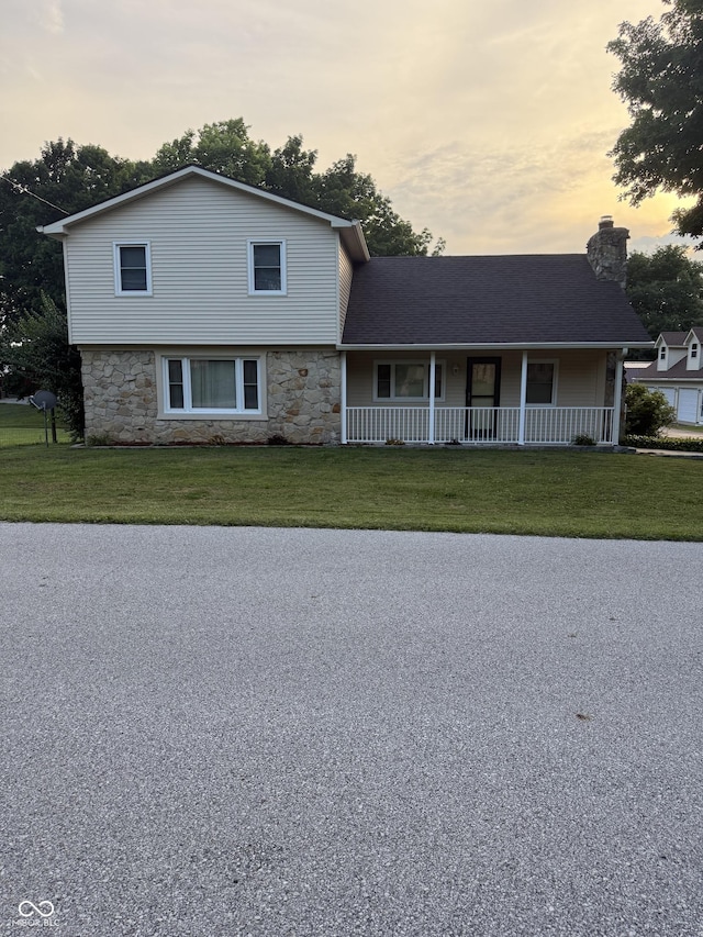 11698 N Bethesda Rd, Mooresville, IN 46158 - view of front of property with covered porch, a front lawn, a chimney, and stone siding