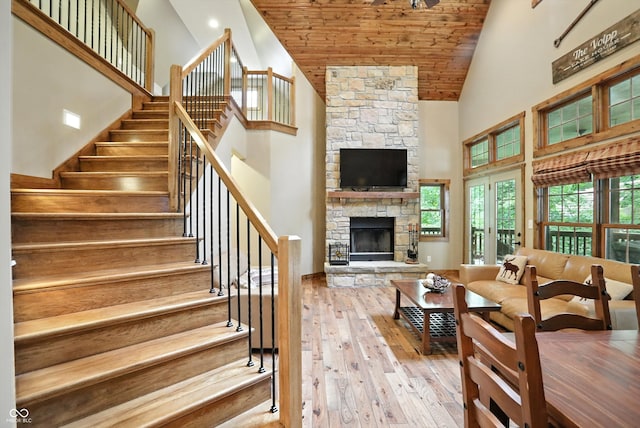 7563 Grizzly Dr, Nineveh, IN 46164 - living area with high vaulted ceiling, hardwood / wood-style flooring, a fireplace, wooden ceiling, and stairs