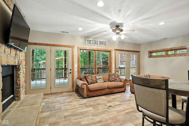 7563 Grizzly Dr, Nineveh, IN 46164 - living area featuring french doors, a fireplace, recessed lighting, ceiling fan, and light wood finished floors