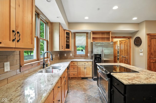7563 Grizzly Dr, Nineveh, IN 46164 - kitchen with stainless steel appliances, recessed lighting, tasteful backsplash, a kitchen island, and light stone counters