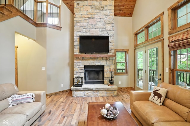7563 Grizzly Dr, Nineveh, IN 46164 - living area with high vaulted ceiling, hardwood / wood-style floors, a stone fireplace, and wooden ceiling
