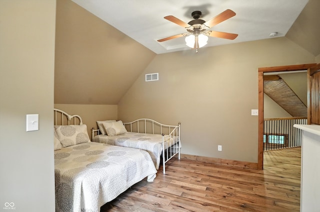 7563 Grizzly Dr, Nineveh, IN 46164 - bedroom featuring wood finished floors, vaulted ceiling, and a ceiling fan