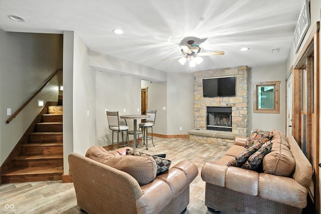 7563 Grizzly Dr, Nineveh, IN 46164 - living room with wood finished floors, ceiling fan, stairway, a stone fireplace, and recessed lighting
