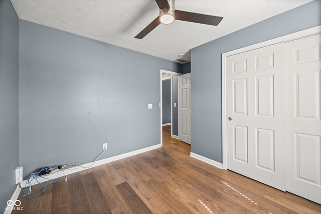 3914 Chenango Pl, West Lafayette, IN 47906 - unfurnished bedroom featuring wood finished floors, a textured ceiling, a ceiling fan, and a closet