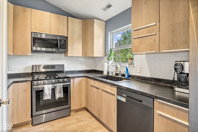 3914 Chenango Pl, West Lafayette, IN 47906 - kitchen featuring appliances with stainless steel finishes, light brown cabinetry, dark countertops, and lofted ceiling