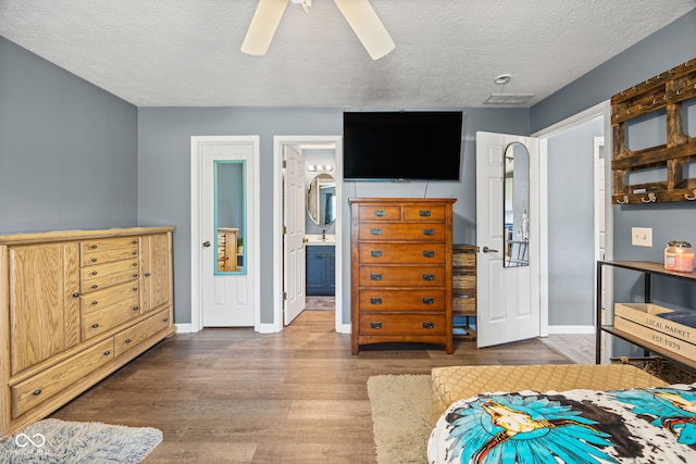 3914 Chenango Pl, West Lafayette, IN 47906 - bedroom with wood finished floors, a textured ceiling, a ceiling fan, and connected bathroom
